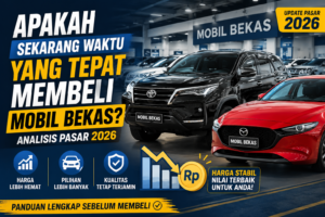 Thumbnail artikel otomotif menampilkan SUV hitam dan hatchback merah di showroom mobil bekas dengan judul "Apakah Sekarang Waktu yang Tepat Membeli Mobil Bekas?" serta informasi analisis pasar mobil bekas tahun 2026.